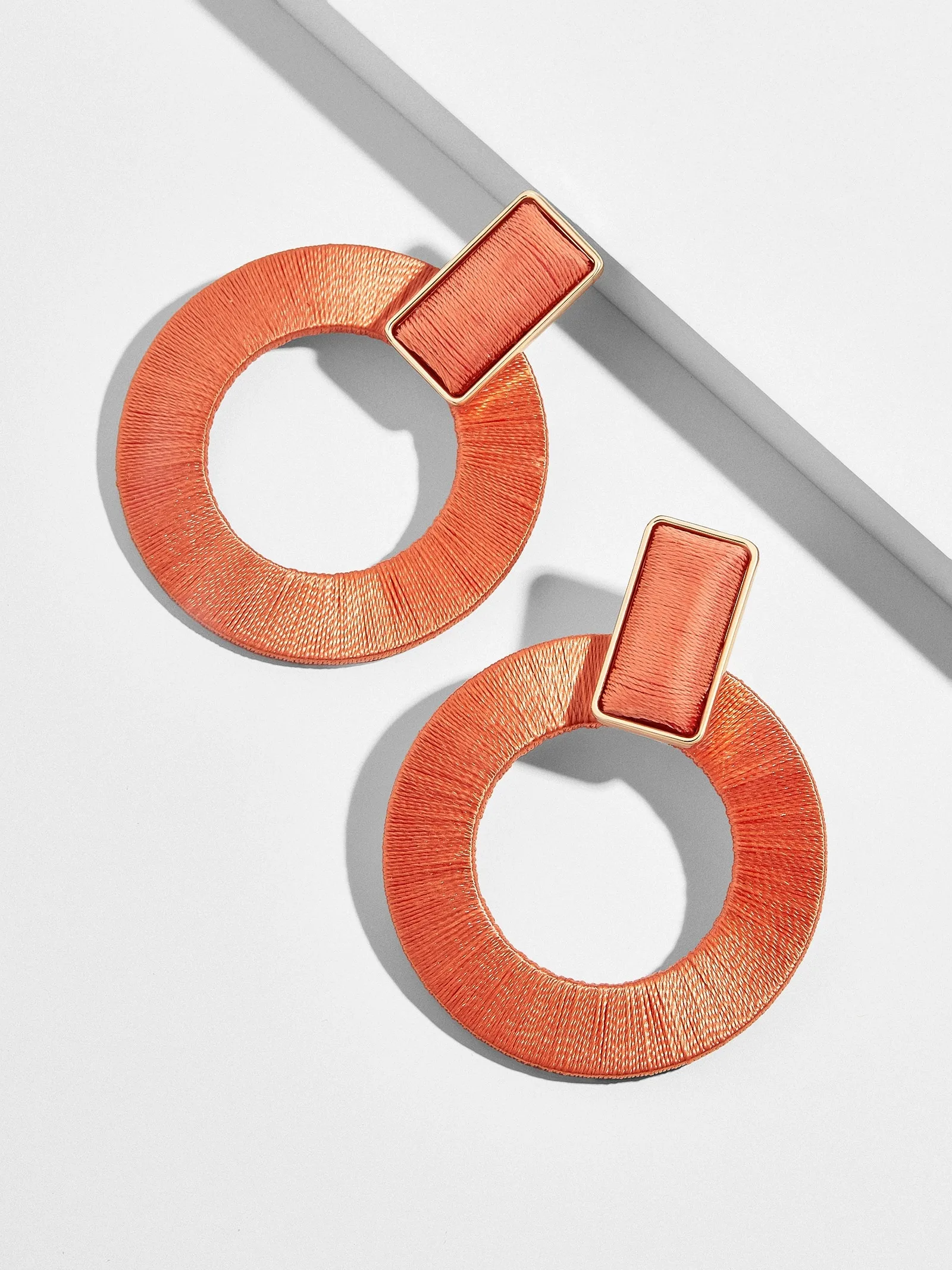 Coral marisella woven hoop drop earrings in coral at BaubleBar
