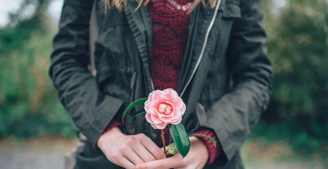 Woman Bringing Flowers To A Friend