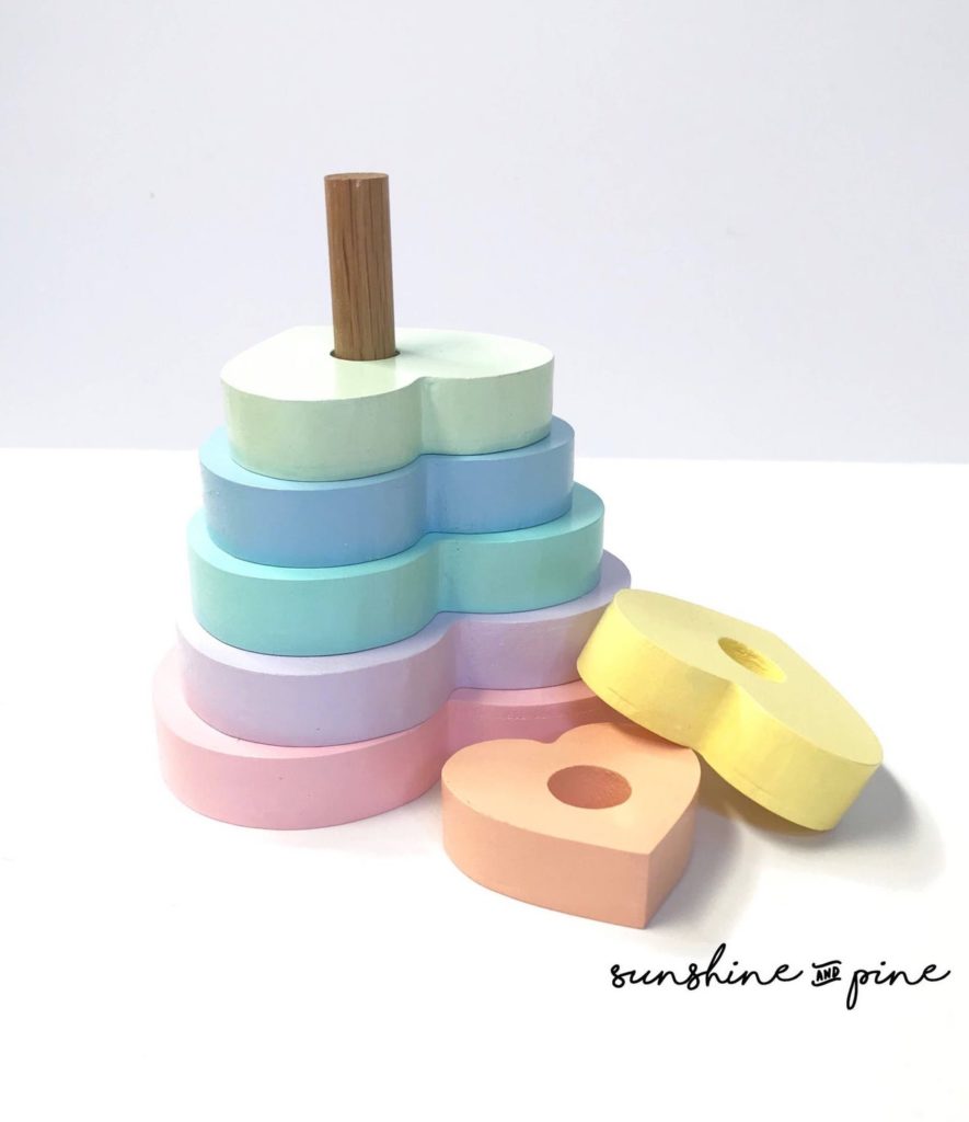 Best baby shower gifts under $50: Handmade wooden pastel rainbow heart stacker | Cool Mom Picks Baby Shower Gift Guide