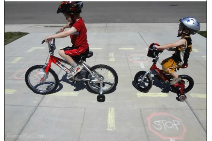 Creating a bike chalk road to teach bike safety right in your driveway