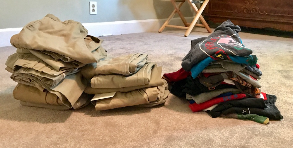 How to make a capsule wardrobe for kids: Piles of clothes, before.