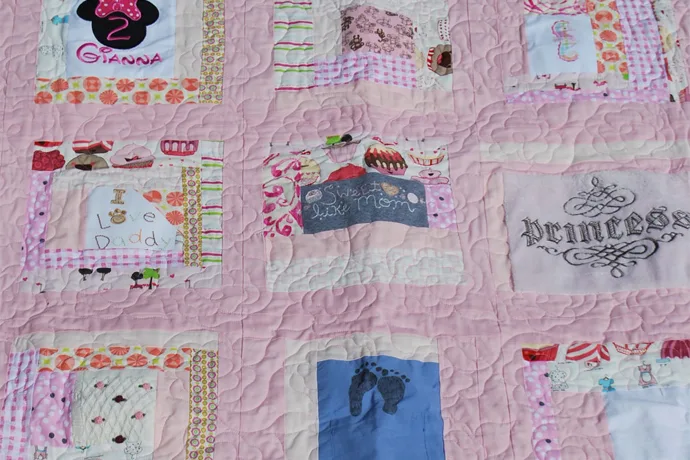Quilt made out of baby clothes