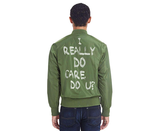 I Really Do Care Do U bomber jacket, with 100% of the proceeds supporting RAICES #keepfamiliestogether