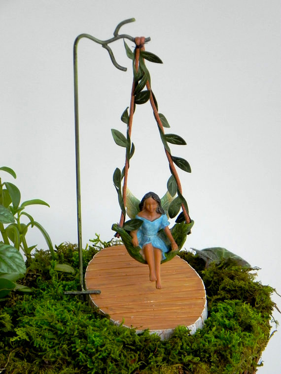 Fairy garden ideas: Mini fairy garden figurine swinging from a leaf