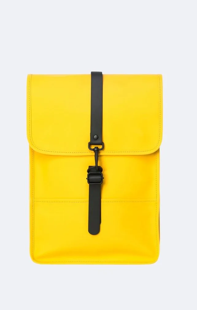 Cute summer backpacks: Rains Waterproof Mini Backpack is perfect for a laptop in Pantone's Illuminating Yellow color of 2021